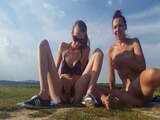 Two girls squirt and piss outdoors